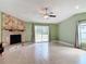Inviting living room featuring a stone fireplace and sliding glass doors to the outdoors at 16 Big Buck Trl, Ormond Beach, FL 32174