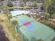 Aerial view of the community's new pickleball court, pool, clubhouse, and beautifully landscaped grounds at 16 Big Buck Trl, Ormond Beach, FL 32174