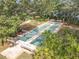 Aerial view of a shuffleboard court and wooden benches surrounded by palms and mature trees at 16 Big Buck Trl, Ormond Beach, FL 32174