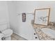 Well-lit bathroom featuring a new toilet, granite countertop, and modern towel rack at 1600 S Palmetto Ave # 105, South Daytona, FL 32119