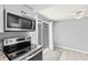 Close view of kitchen cooktop and sliding glass door to the back yard and patio at 1600 S Palmetto Ave # 105, South Daytona, FL 32119