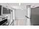 Well-lit kitchen with stainless steel appliances and view to back patio through sliding glass door at 1600 S Palmetto Ave # 105, South Daytona, FL 32119