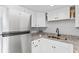 Modern kitchen featuring white cabinets, granite countertops, and stainless steel appliances at 1600 S Palmetto Ave # 105, South Daytona, FL 32119