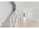 Open-concept living room showcasing tile floors and a staircase, perfect for modern living at 1600 S Palmetto Ave # 105, South Daytona, FL 32119