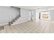 Spacious living room with tile flooring, adjacent to the staircase and kitchen area at 1600 S Palmetto Ave # 105, South Daytona, FL 32119