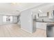 Open-concept living area into kitchen, featuring tile floors, and stainless steel appliances at 1600 S Palmetto Ave # 105, South Daytona, FL 32119