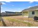Spacious backyard with a covered patio area, privacy fence, and a grassy lawn at 1626 Lansfield Ave, Deltona, FL 32738