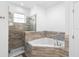 Bathroom featuring a glass enclosed shower with a soaking tub and modern tile at 1626 Lansfield Ave, Deltona, FL 32738