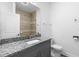 Bathroom featuring granite countertops, neutral tile, and modern fixtures at 1626 Lansfield Ave, Deltona, FL 32738