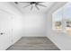 Neutral bedroom with a ceiling fan, ample natural light, and modern flooring at 1626 Lansfield Ave, Deltona, FL 32738