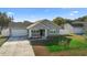 Charming single-story home with a well-manicured lawn and a spacious two-car garage at 1626 Lansfield Ave, Deltona, FL 32738