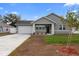 Charming single-story home with a well-manicured lawn and a spacious two-car garage at 1626 Lansfield Ave, Deltona, FL 32738