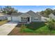 Charming single-Gathering home with a well-manicured lawn, attached garage and cozy front porch at 1626 Lansfield Ave, Deltona, FL 32738