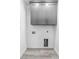 Neutral laundry room with grey upper cabinets and modern flooring at 1626 Lansfield Ave, Deltona, FL 32738