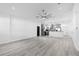 Open-concept living room with vaulted ceilings, a ceiling fan, and light wood flooring at 1626 Lansfield Ave, Deltona, FL 32738