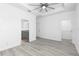 Spacious bedroom featuring modern ceiling fan, bathroom, and walk-in closet at 1626 Lansfield Ave, Deltona, FL 32738
