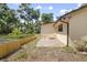 House corner with a small window in the backyard featuring a wood fence and a concrete slab at 1690 S Adelle Ave, Deland, FL 32720