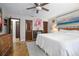 Spacious bedroom featuring a ceiling fan, tiled floors, and eclectic decor and furnishings at 1690 S Adelle Ave, Deland, FL 32720