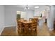 Bright dining room with wood table, chairs, and views of the kitchen with white cabinetry at 1690 S Adelle Ave, Deland, FL 32720