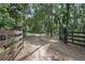 Gated entrance on a long private driveway surrounded by trees at 1690 S Adelle Ave, Deland, FL 32720
