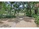 Long view of a one-story house through the trees at 1690 S Adelle Ave, Deland, FL 32720