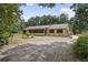 Charming single-story home with lush landscaping and a long driveway at 1690 S Adelle Ave, Deland, FL 32720