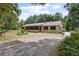 Charming single-story home with lush landscaping and a long driveway at 1690 S Adelle Ave, Deland, FL 32720