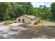 Aerial view showing landscaping, patio, and house exterior, highlighting property layout at 1690 S Adelle Ave, Deland, FL 32720