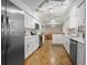 Open kitchen featuring white cabinets, stainless steel appliances, and adjacent dining area at 1690 S Adelle Ave, Deland, FL 32720