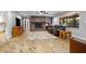 Inviting living room featuring a cozy brick fireplace and comfortable seating area at 1690 S Adelle Ave, Deland, FL 32720