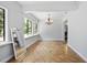 Bright living area featuring a chandelier, tiled floors, and large windows at 1690 S Adelle Ave, Deland, FL 32720