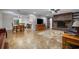 Open-concept living room with fireplace, tile flooring, and dining area at 1690 S Adelle Ave, Deland, FL 32720