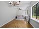 Sunny living area featuring large windows, a comfortable sofa, and tiled floors at 1690 S Adelle Ave, Deland, FL 32720