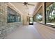 Enclosed patio with brick and vinyl siding and ceiling fans at 1690 S Adelle Ave, Deland, FL 32720