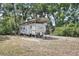 Coachmen RV parked under a metal awning amid lush trees at 1690 S Adelle Ave, Deland, FL 32720