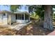 Backyard featuring a patio, enclosed sunroom, large trees, and shade at 175 Center St, Daytona Beach, FL 32117