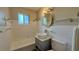 Bright bathroom with a unique vessel sink, tiled walls, and a combined tub and shower at 175 Center St, Daytona Beach, FL 32117