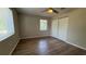 Bedroom with wood-look floors, ceiling fan, closet, and bright natural light from the two windows at 175 Center St, Daytona Beach, FL 32117