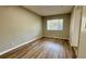 Cozy bedroom featuring wood-look flooring, natural light, and a clean, minimalist design at 175 Center St, Daytona Beach, FL 32117