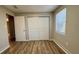Bedroom featuring a closet and wood-look floors, filled with natural light from the window at 175 Center St, Daytona Beach, FL 32117