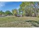 Large, fenced backyard with a storage shed and mature shade trees at 183 Mcgregor Rd, Deland, FL 32720