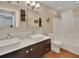 Bathroom with double vanity, modern fixtures, large mirror, and a bathtub with shower at 183 Mcgregor Rd, Deland, FL 32720