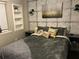 Cozy bedroom with decorative wall, stylish lighting, and built-in shelving for added storage and display at 183 Mcgregor Rd, Deland, FL 32720