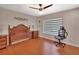Spacious bedroom features a wooden bed frame, ceiling fan, and natural light from the window at 183 Mcgregor Rd, Deland, FL 32720