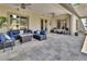 Relax on this covered patio with stone floors and comfy seating around a fire pit table at 183 Mcgregor Rd, Deland, FL 32720