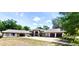 Expansive single-story home featuring two garages, a horseshoe driveway and tropical landscaping at 183 Mcgregor Rd, Deland, FL 32720