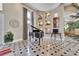 Elegant foyer with decorative shelving and stylish accents, piano, marble tile flooring, and tray ceilings at 183 Mcgregor Rd, Deland, FL 32720