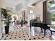 Bright foyer with piano, marble tile flooring, tray ceilings and bright natural light from the front door at 183 Mcgregor Rd, Deland, FL 32720