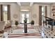 Spacious foyer with piano, decorative rug, marble tile flooring, tall windows and bright natural light from the front door at 183 Mcgregor Rd, Deland, FL 32720