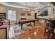 Spacious game room featuring a pool table, shuffleboard table, large TV, and hardwood floors at 183 Mcgregor Rd, Deland, FL 32720